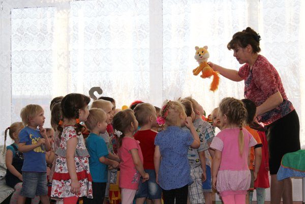 Воспитательница показывает детям игрушку-лисичку