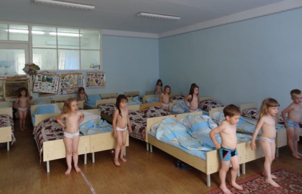 Дети в трусиках стоят рядом с кроватями